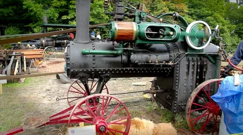 A steam engine tractor generates power to operate a pony saw mill. Stock Footage 12156997