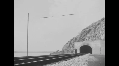 Steam engine train exits the railroad tunnel - 1940 Stock Footage 101430005