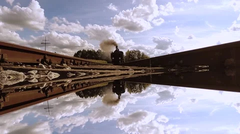 Steam engine train locomotive driving over camera. mirror reflection background Video stock 64540310