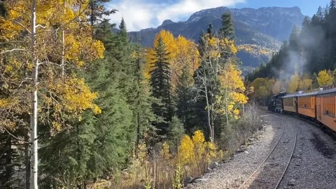 Steam Engine Train Ride Through Fall Foliage in Rocky Mountains Stock Footage 274865505