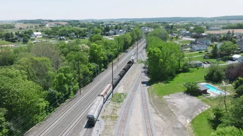 Steam Freight Train Backs Up in Yard in Rural Landscape Near Small Town on .. Stock Footage 321650749
