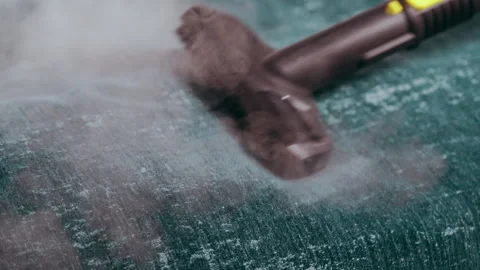 The steam generator brush cleans the sofa upholstery. Video stock 312625584