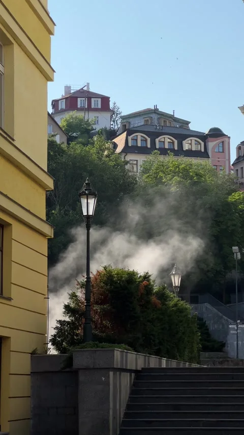 Steam from hot spring in morning sunlight in Karlovy Vary. Vertical Stock Footage 246972606