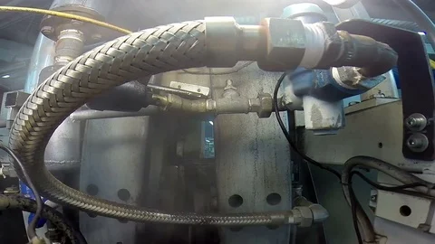 Steam Ironing Machine With a Cloud of Hot Steam in a Textile Industry Stock Footage 72296784