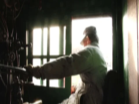 Steam locomtive engineer at controls looks forward and back Stockbeeldmateriaal 71548699