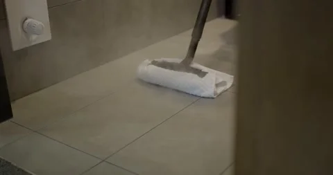 Steam Mop With Cloth Pad Cleaning a Tile Floor by a Room Door Stock Footage 340272298