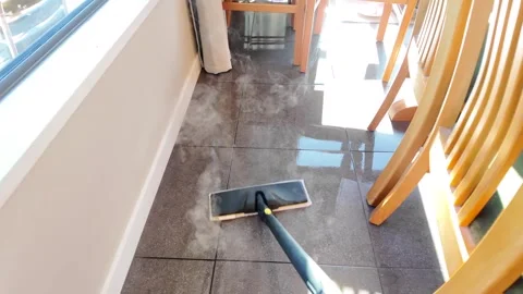 Steam mop in use releasing thick vapor Stock Footage 329013584