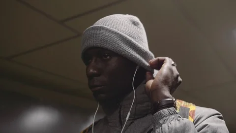 Steam from the mouth of african young man, walks at night in subway Stock Footage