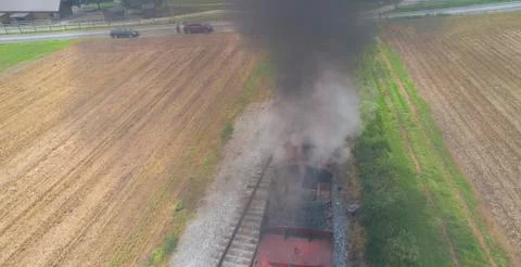 Steam Passenger Train Pulling into Picnic Area by Drone Foto stock