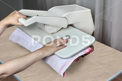 Steam press machine for home, female hands iron bed linens. Stock Photos