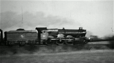 Steam railway locomotive engine on a passenger train in an old B&amp;W film Stock Footage 10868725