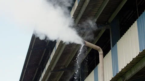 Steam release from a processing pipe at a palm oil factory. Видео 346104713