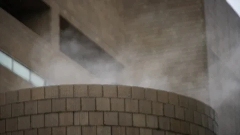 Steam rises from boiler on cold rainy day 스톡 동영상 106341871