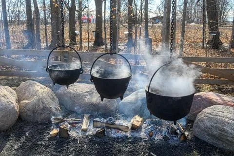 Steam Rises from Cauldrons at Maple Syrup Festival Stock Photos