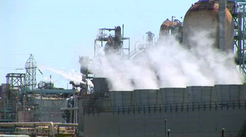 Steam rises from evaporative stacks at a power facility. Video stock 558066
