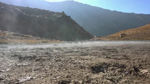 Steam rises from the ground in the mountains. Video stock 212998046