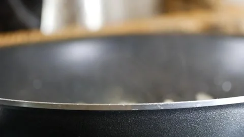 Steam rises from a pan on the kitchen countertop, filling the air with enticing Stock Footage 293754742