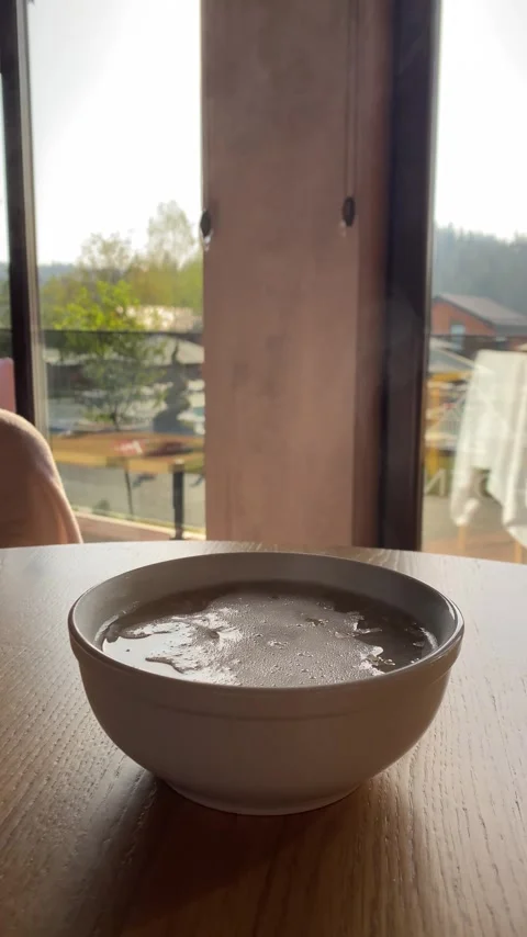Steam rises from a plate of oatmeal Stock Footage 284360085