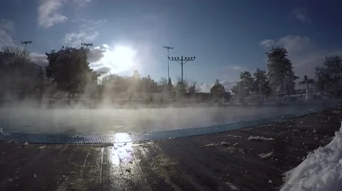 Steam rises slowly over an open swimming pool Stockbeeldmateriaal 69036992