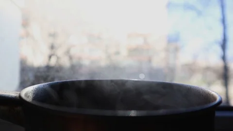 Steam rises while cooking in a pan. Open a small pan with steam. Stock Footage 127653823
