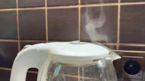 Steam Rising from Boiling Kettle on Dark Kitchen Background Stock Footage 310872369