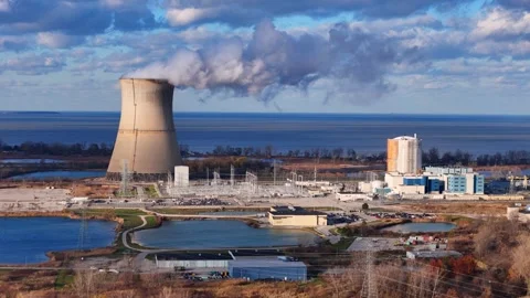 Steam rising from the cooling tower of the Davis-Besse nuclear power plant in Stock Footage 340391118