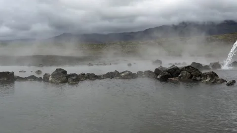 Steam Rising from a Geothermal Hot Spring in an Icelandic Landscape Stock Footage 339633394