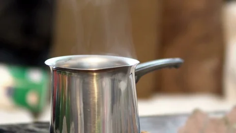 Steam Swirling Up From Pot Of Boiling Water On Red Hot Electric