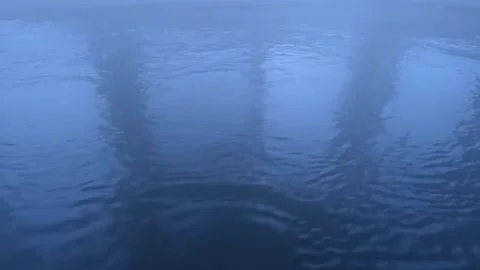 Steam rising up from surface of  hot-spring pool water Stock Footage 303251975