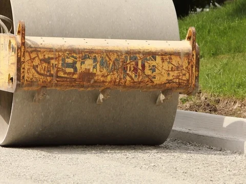 Steam roller rolls over pavement Vídeo Stock 77312423