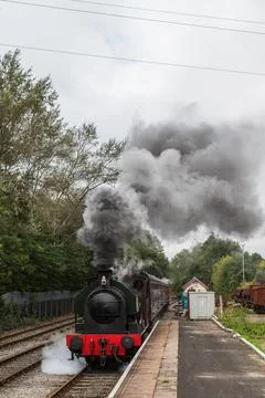 Steam train approaching a platform Stock Photos