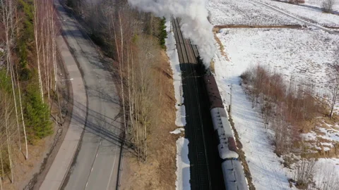 Steam train between a field and a road Stock Footage 236220273