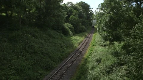 Steam Train Comes Around The Corner In Yorkshire Moors Stock Footage 240948487