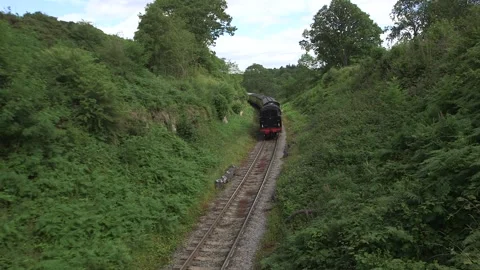 Steam train coming around the corner in Yorkshire countryside Stock Footage 240415759