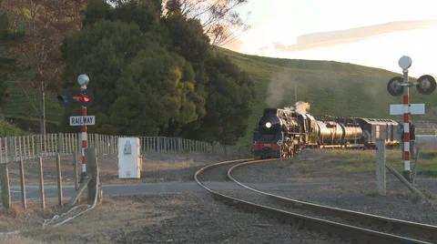 Steam train on corner in setting sun Stock Footage 883597
