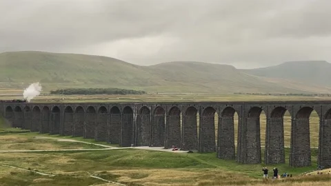 Steam train crossing viaduct Stock Footage 168075896