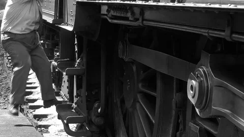 Steam Train engine driver climbs down from train black and white 4K Stock Footage 77417594