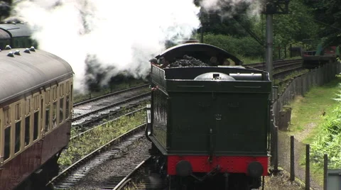 Steam train leaving station Stockbeeldmateriaal 65256661