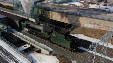 Steam train leaving the station over the bridge Stock Footage 236220264