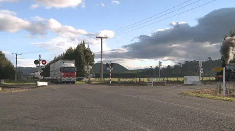 Steam train at level crossing Stock Footage 882640