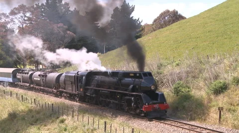 Steam train makes its way up hill Stock Footage 41544058
