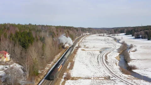 Steam train moving along the winter field Stock Footage 236220493