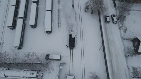 Steam Train Moving Through Snowy Railway Yard Aerial Stock Footage 341765949