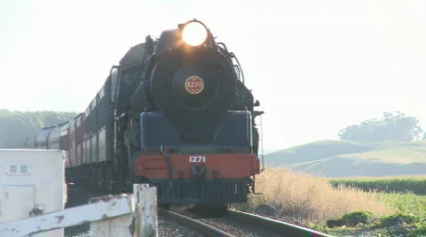 Steam train passes through road intersection Stock-Footage 636800