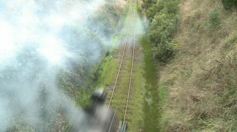 Steam train passes under bridge Stock Footage 641060