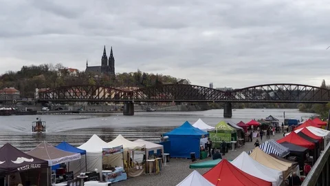 Steam Train passing over the Vltava next to riverside markets Stock Footage 91398849