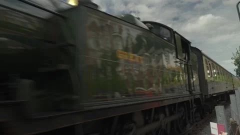 Steam train passing with reflections of houses in the windows. Stock Footage 338034021