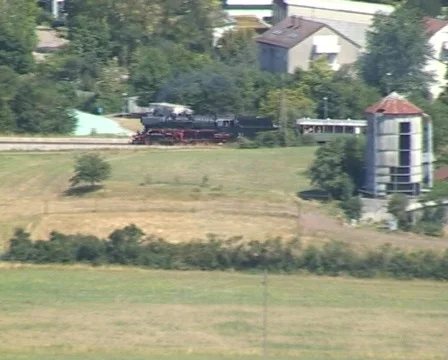 Steam train passing through open fields Stock Footage 312213