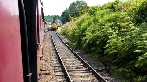 Steam train passing vintage carriages pulled by diesel Stock Footage 80307025
