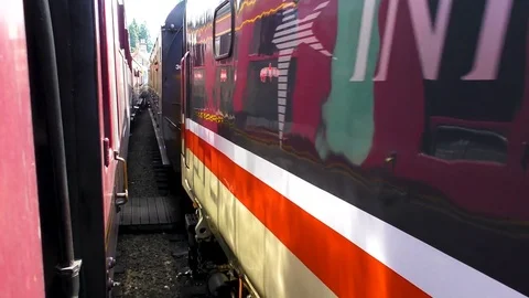 Steam train passing vintage carriages country station Stock Footage 80308149